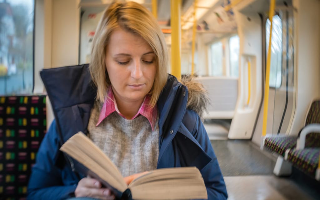 Local Woman Politely Reading On Train Is Getting Through The Most Filthy Smut Right Now