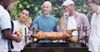 “Surely She’d Be Done By Now” Says Increasingly Drunk Mates Surrounding Spit Roast