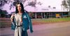 Local Girl Briefly Toys With The Idea Of Putting Arms Through Sleeves Of Jacket Draped Over Shoulders