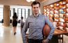 Office Sports Guys Walks Around Open Plan Workspace With Ball Of Some Description