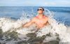 Guy Standing Still In Surf Definitely Pissing