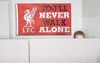 Liverpool Fan’s Coworkers Under Impression YNWA Flag In Cubical Is A Motivational Poster
