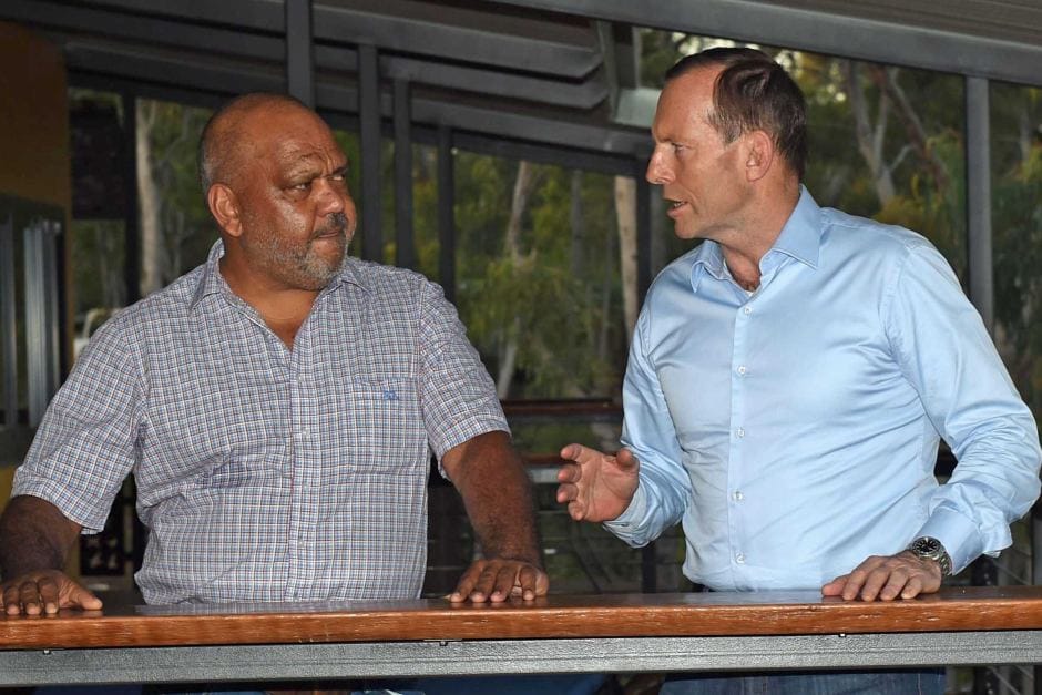 Tony Abbott patronises an Aboriginal boy by patting him on the head despite being offered a handshake