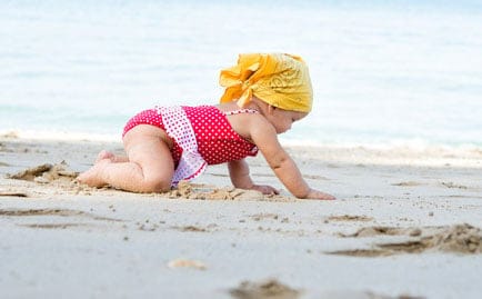 Magnolia's youngest, Aquila , plays in the sand without fear of getting autism from state-sanctioned injections