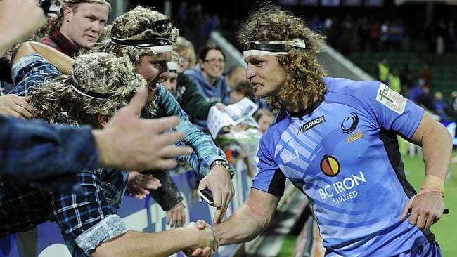 The Honey Badger greets his die-hard fans with a stern handshake