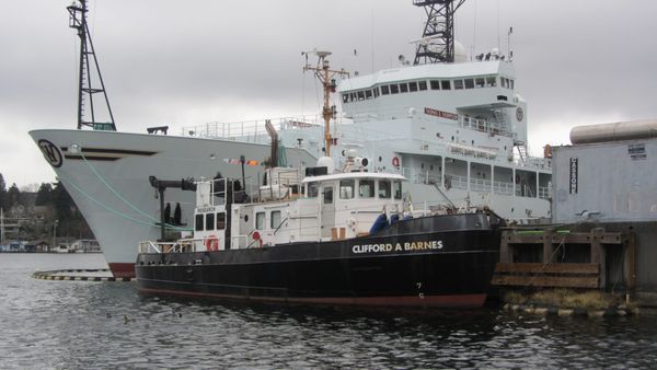 R/V Clifford A. Barnes, the BITT hull during University of Washington research service, moored beside a larger ship.