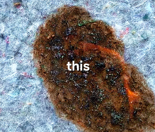 Automotive felt sample after flame test — charred through, smoke visible, wet cloth compression marks on surface, Test 11 of GAUSS Material Trials