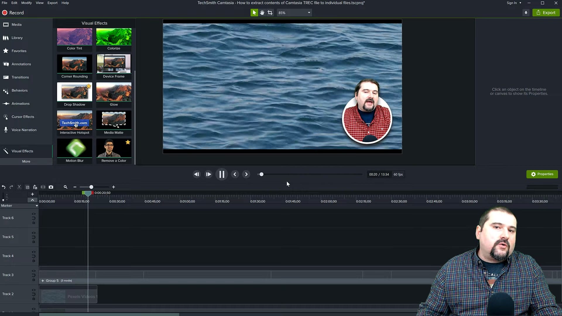 Circular talking head overlay on an ocean video background in Camtasia demonstrating the final composite effect