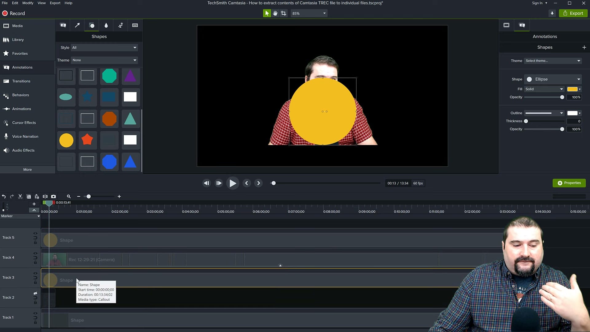 Yellow ellipse shape overlaid on camera footage in Camtasia with Shapes panel and timeline tracks visible