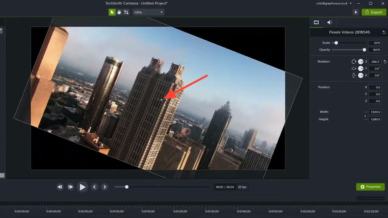 Camtasia canvas showing a city skyline video rotated at an angle using the drag handle, with Z rotation at 368.3 degrees visible in the Properties panel
