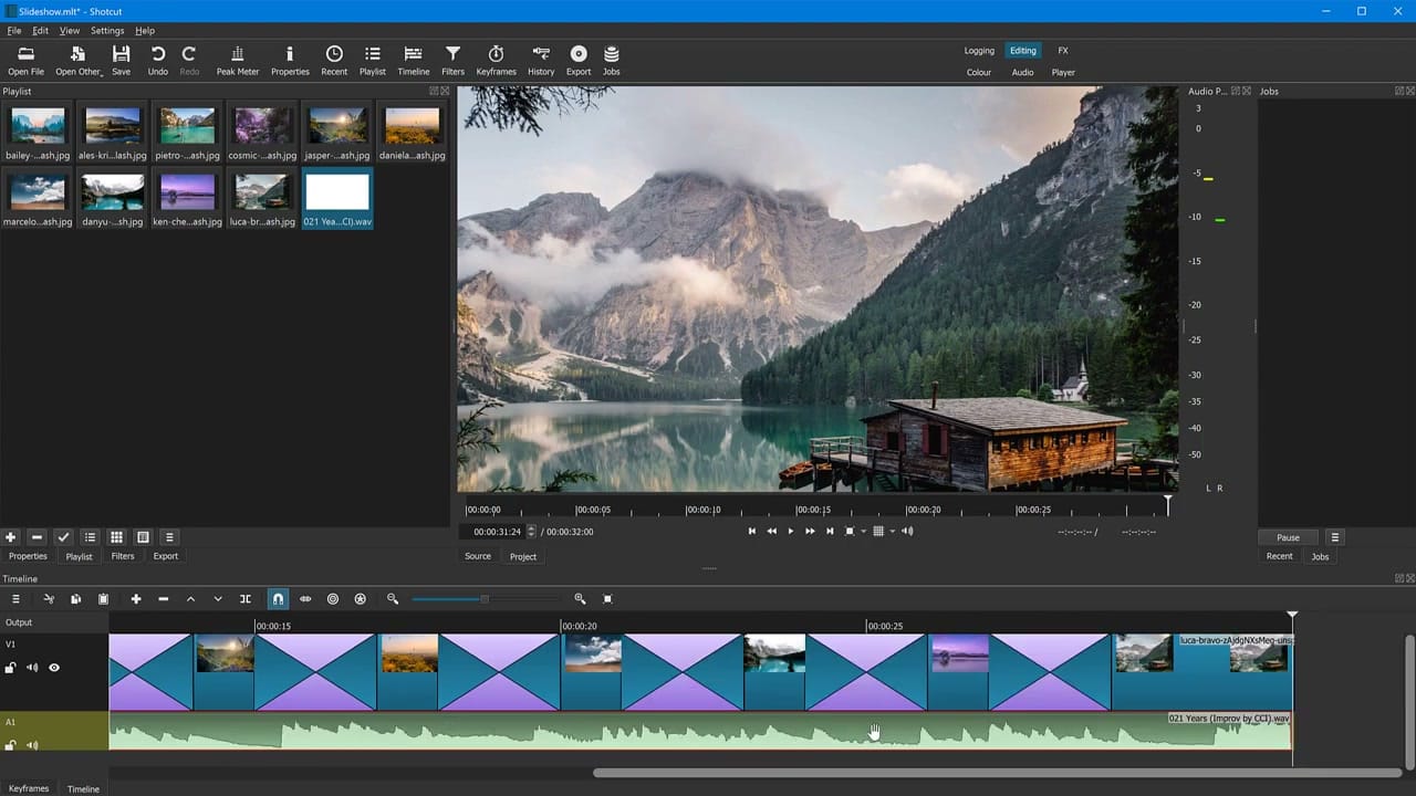 Shotcut timeline with photo slideshow clips on V1 connected by dissolve transitions and music on the A1 audio track