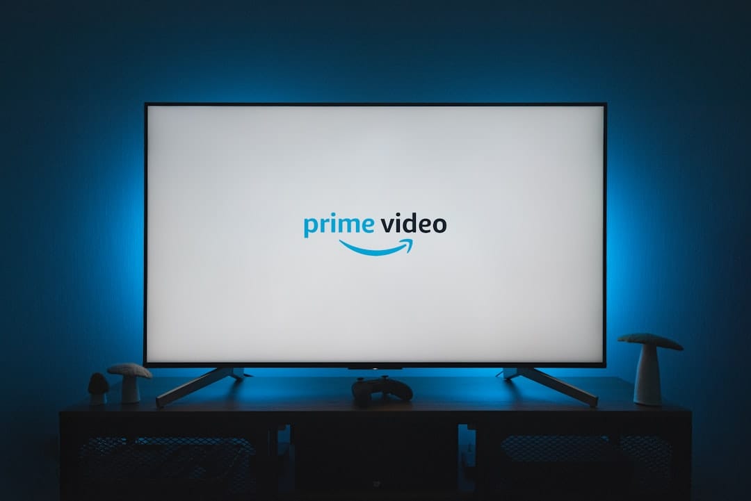 A television screen displaying the Amazon Prime Video logo in a dimly lit room with blue ambient backlight.