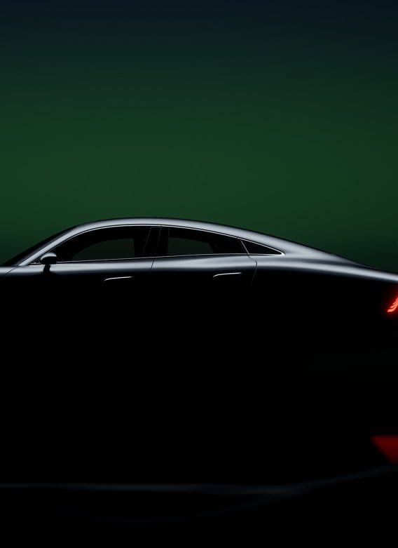 A dark silhouette showing the sleek side profile and roofline of a luxury Mercedes-Benz vehicle against a dark green studio background.