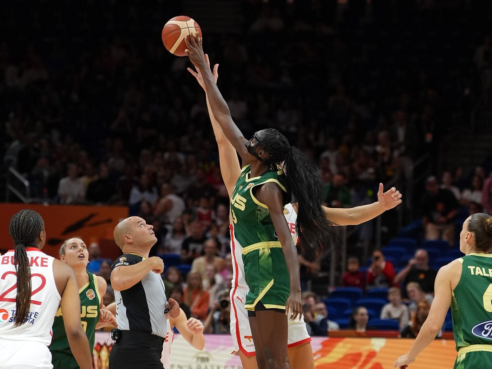 Players from Türkiye and Australia leap for the opening tip-off