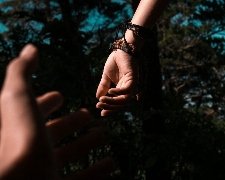 Two hands reaching out for each other