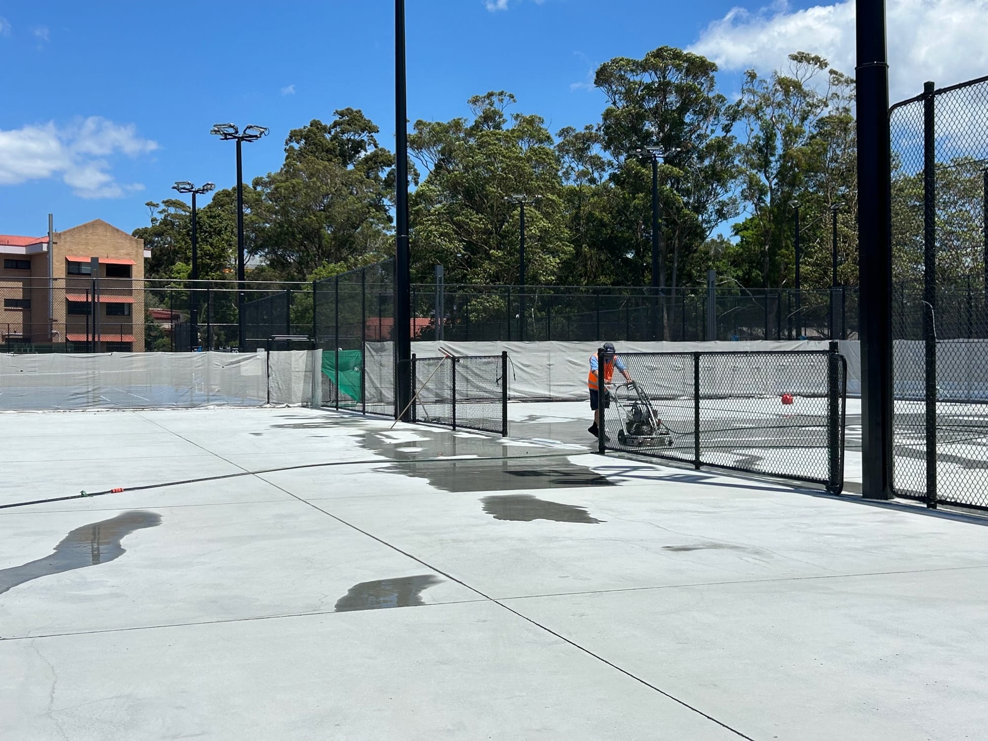 Asbestos, 'bubbling' courts and weather cause delays to new-look Beaton Park tennis centre  post image