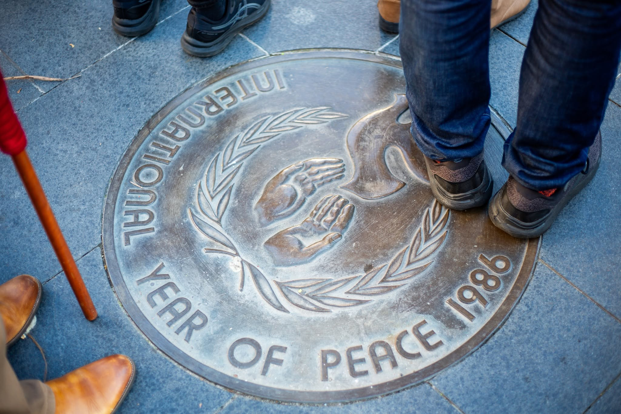 What's behind this well-trodden plaque to peace 
												post image