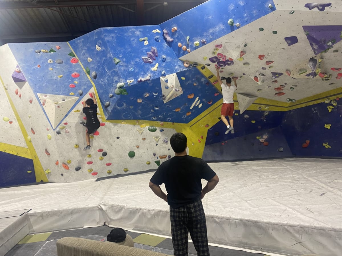 Boulders helping each other solve bouldering problems at Dynomite bouldering gym. Photo: Zach Houtenville