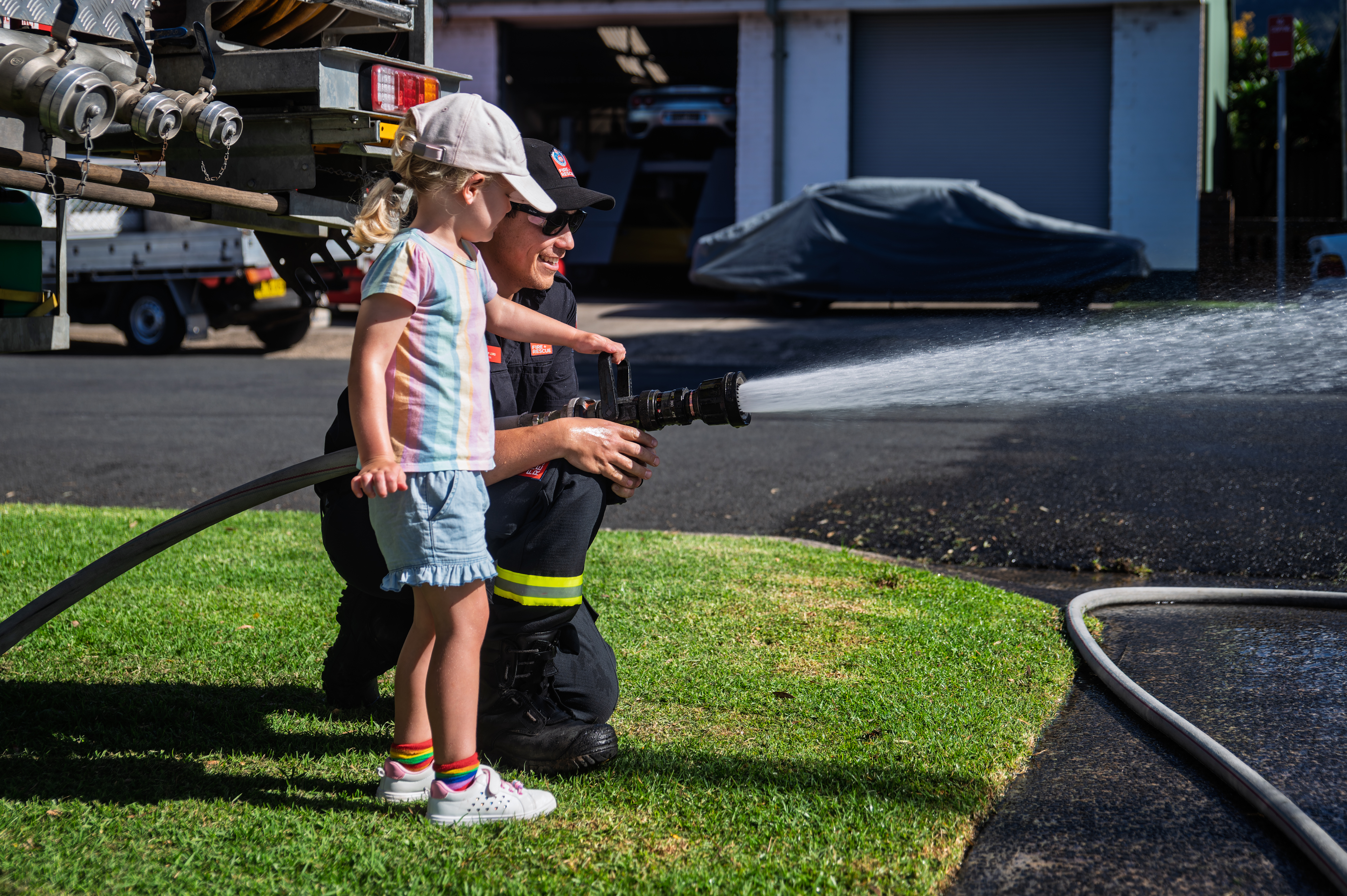 Visitors seize chance to hold a hose at NSW Fire and Rescue Open Day