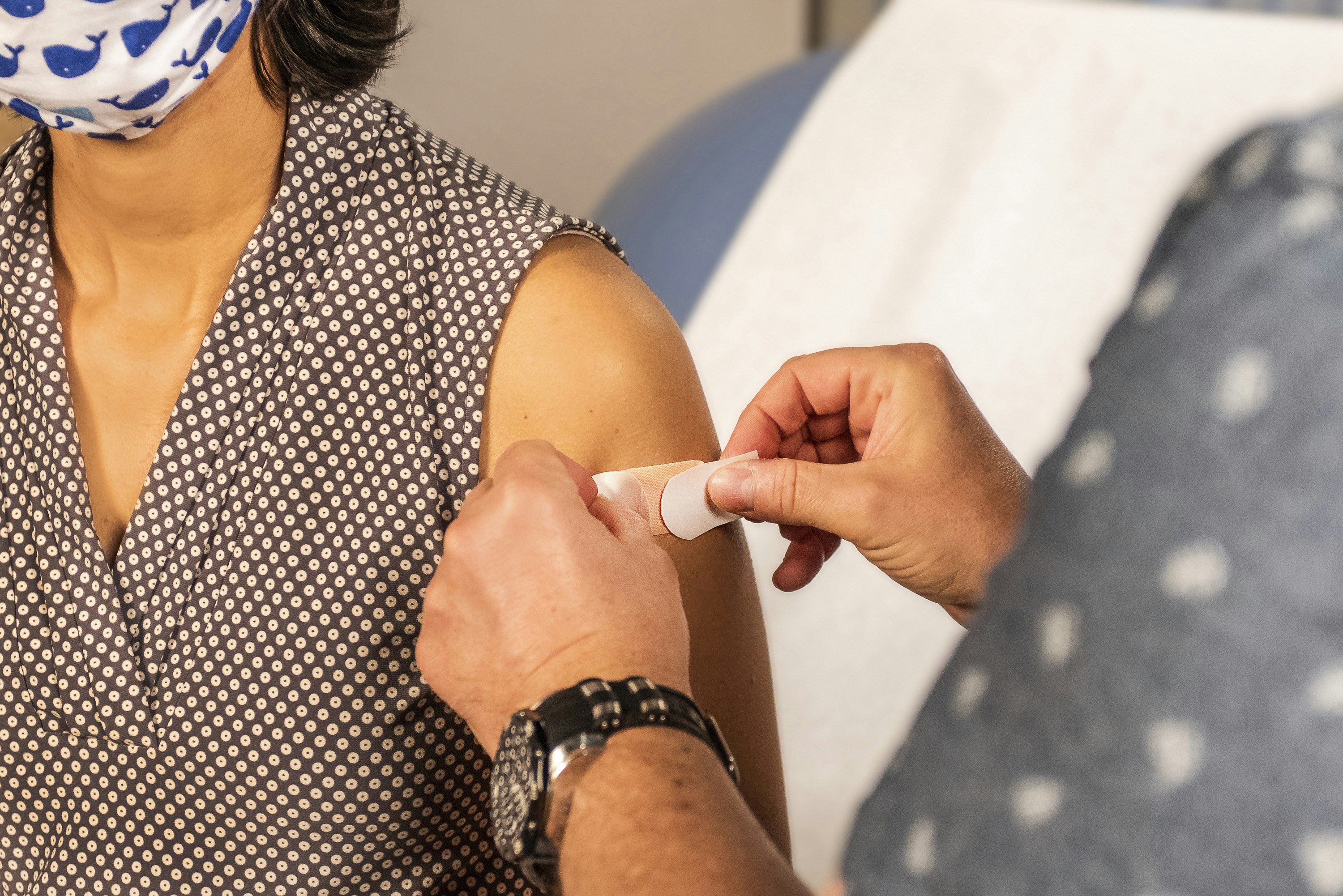 Woman receives vaccination from a health professional