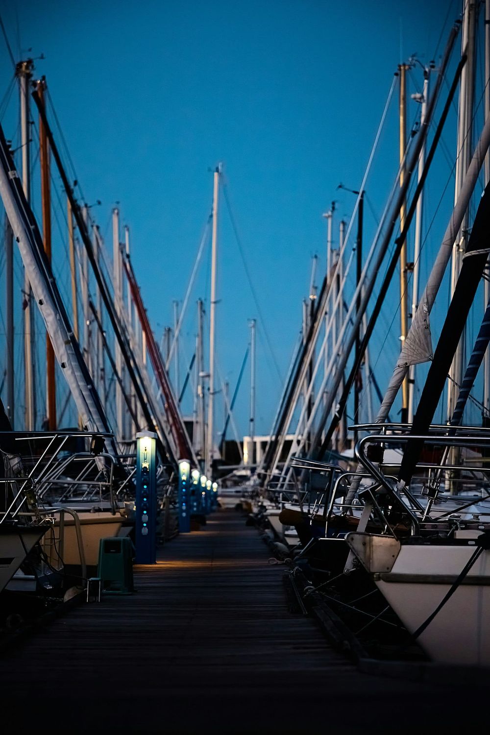 Harbor view with boats moored along a coastal town with hillside