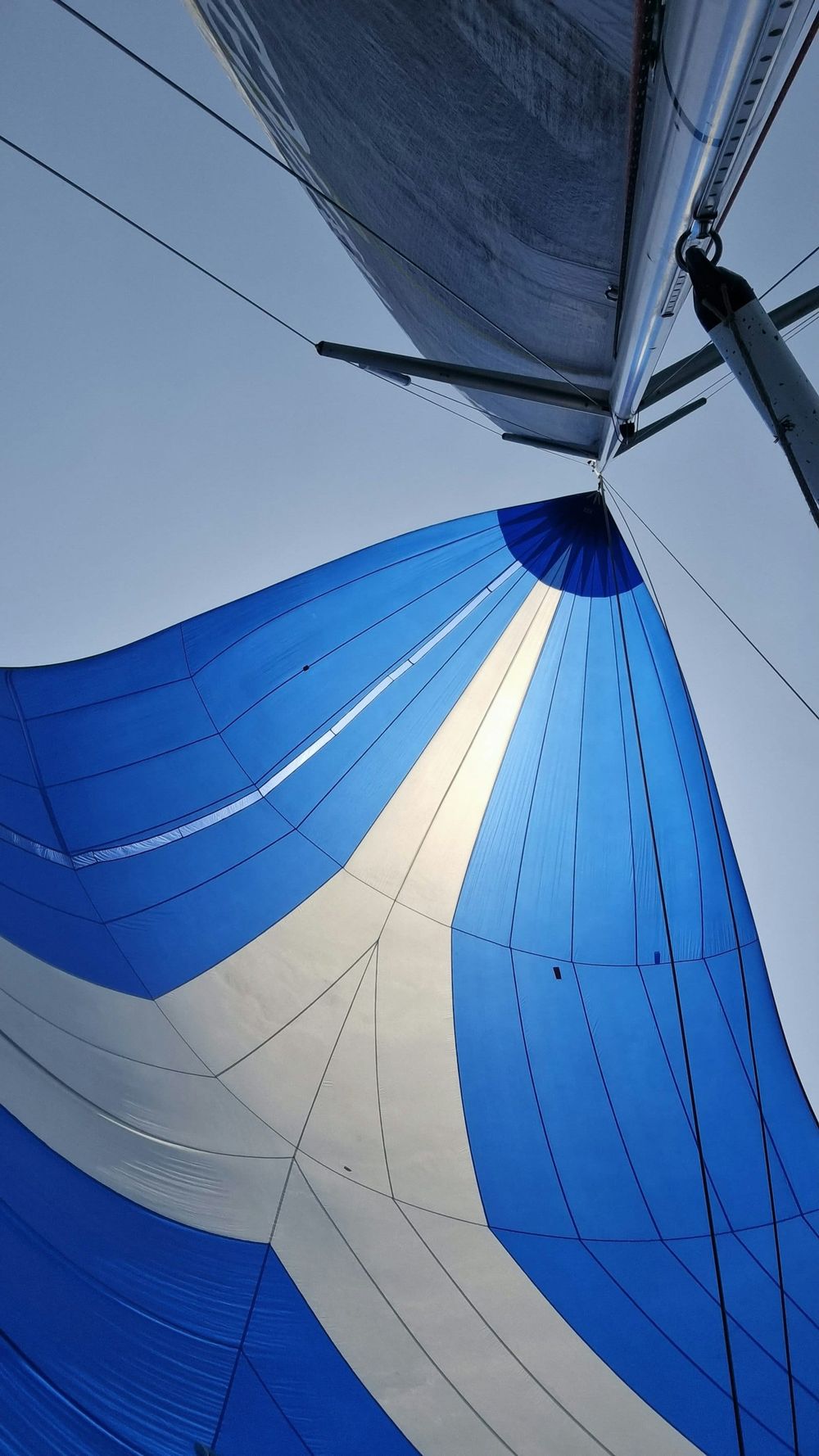 Sailboat flying a colorful spinnaker downwind