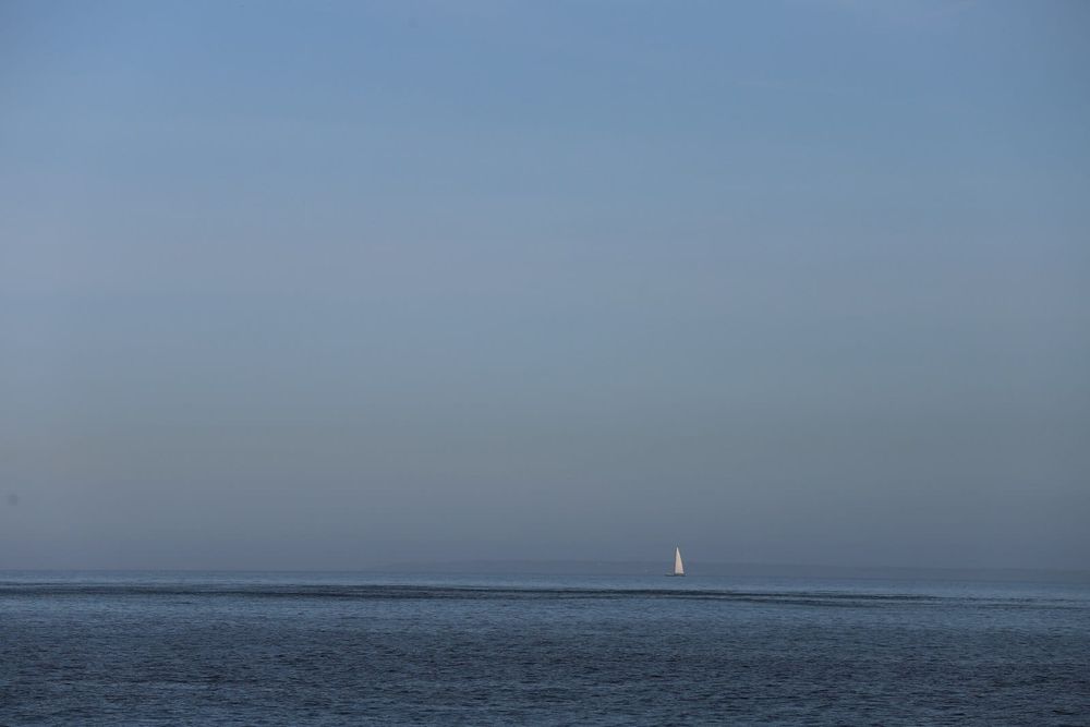 Sailing yacht under engine on a calm offshore morning