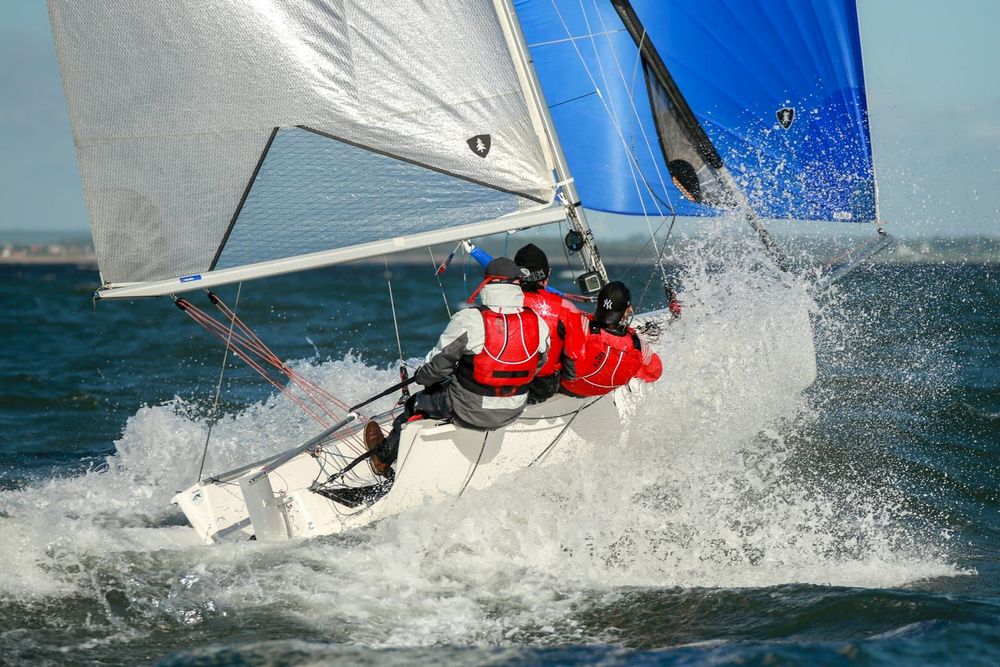 Sailors racing under spinnaker
