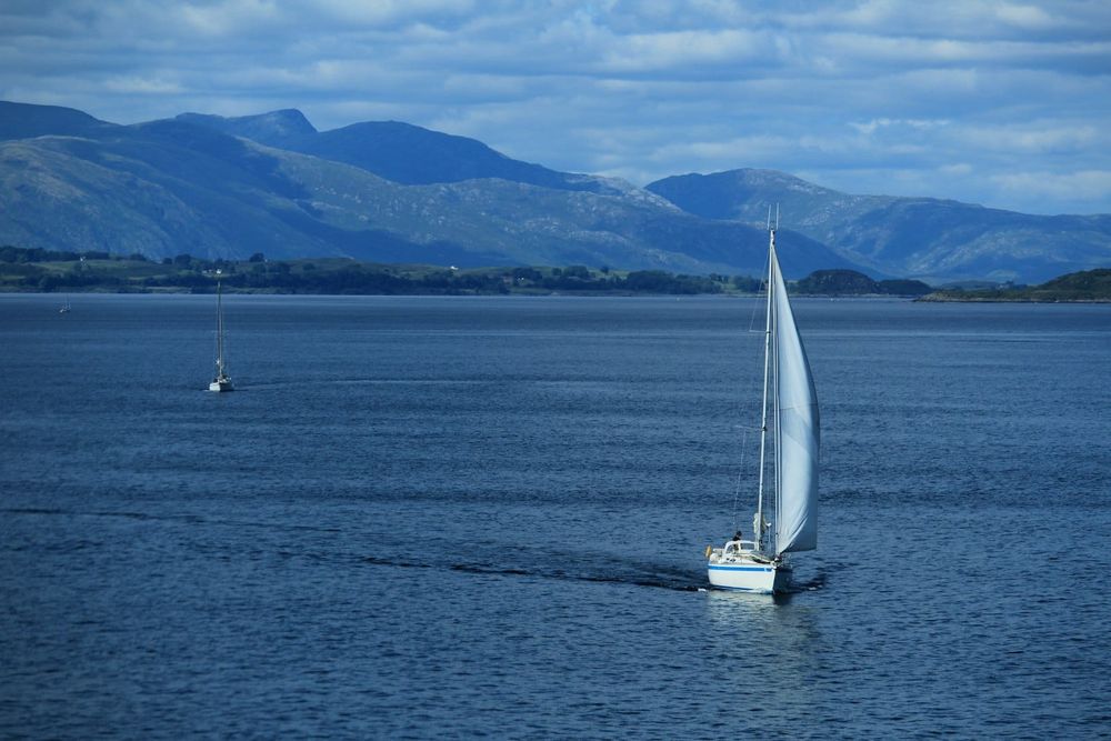 Sailboat on open ocean — tradewinds passage, offshore