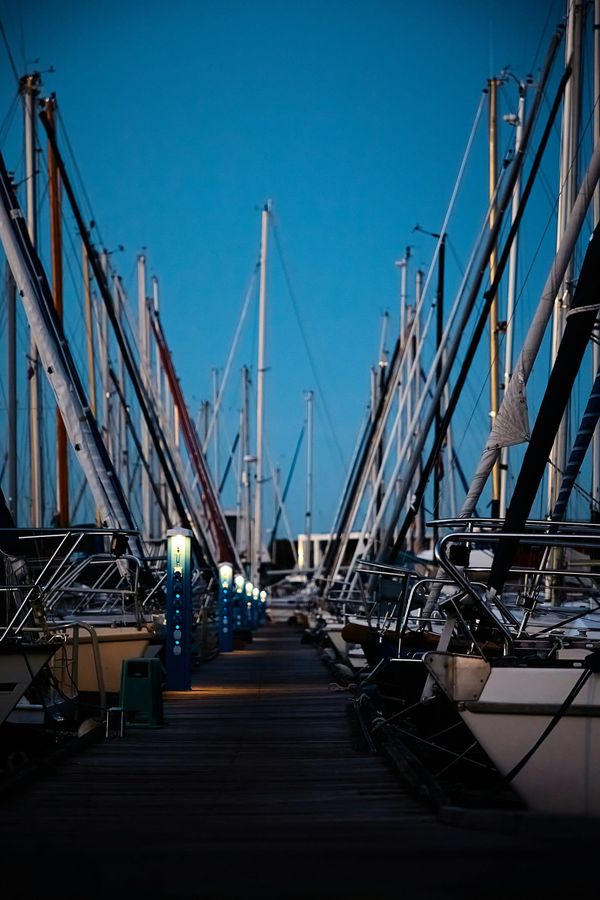 Harbor view with boats moored along a coastal town with hillside