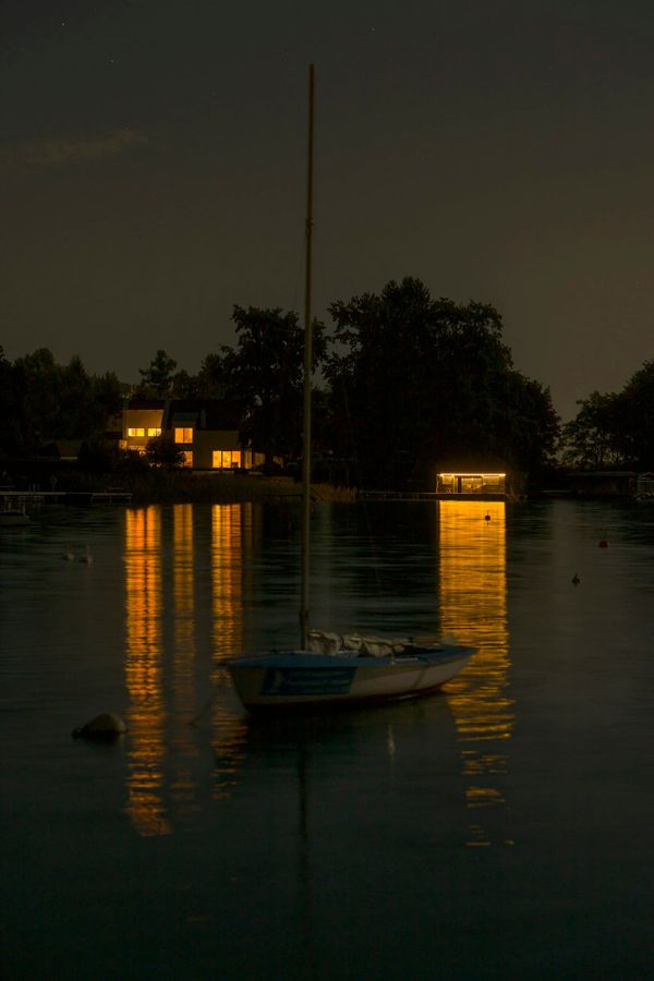 Sailboat at anchor in a calm sheltered bay