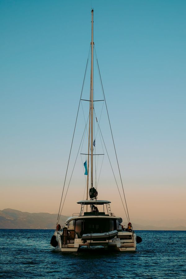 Catamaran masts against evening sky