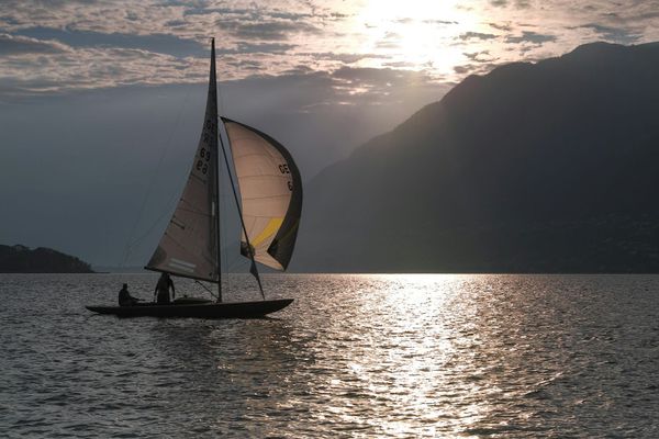 Sailboat with spinnaker at sunset