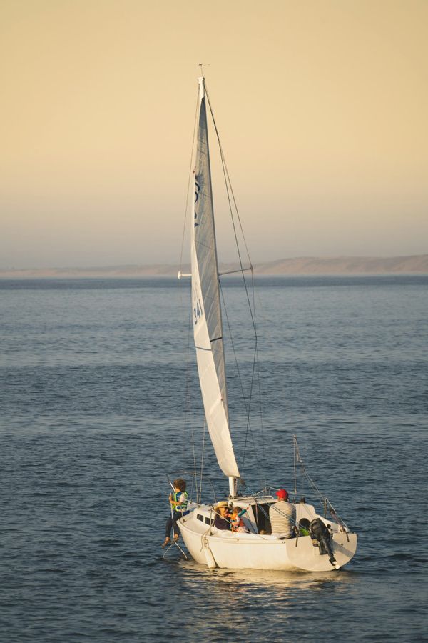 Sailboat at sunset on open water, ocean race