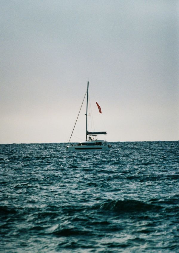 Anchored sailing yacht with mast and flag