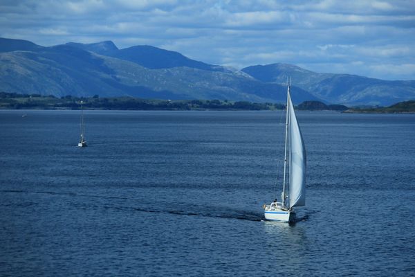 Sailboat on open ocean — tradewinds passage, offshore