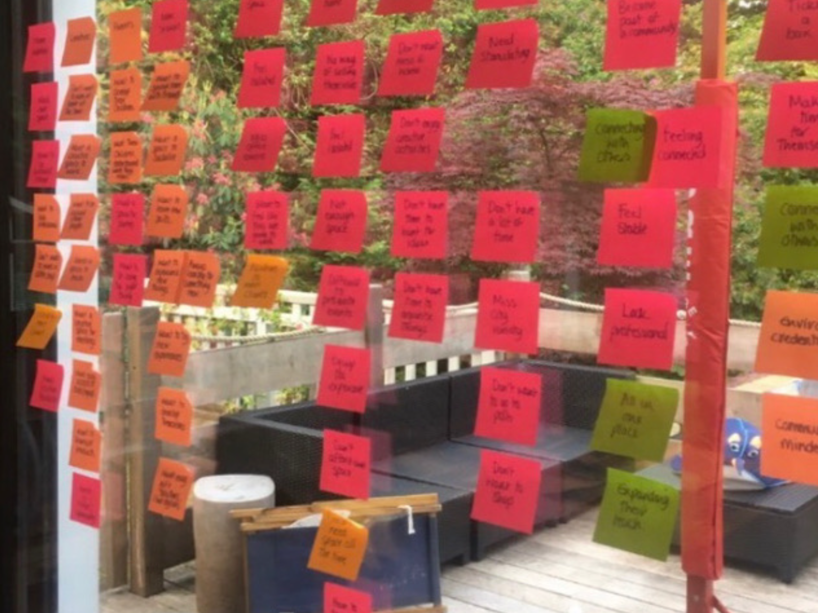 Colourful sticky notes capturing ideas and questions on a window at Inspiration Space