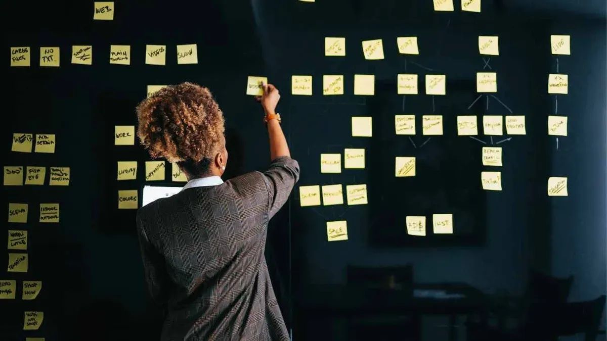 Small business owner strategizing budget-friendly marketing tactics - The Inspiration Space