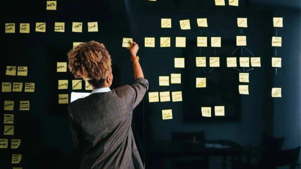 Small business owner strategizing budget-friendly marketing tactics - The Inspiration Space