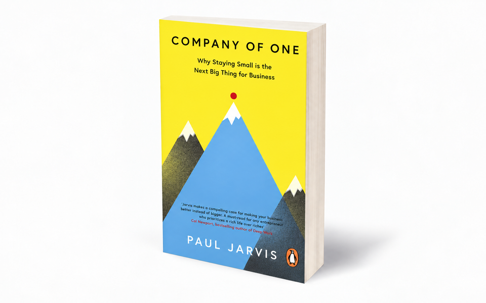 Three-dimensional paperback mock-up of Company of One by Paul Jarvis, with its yellow cover and blue mountain illustration.