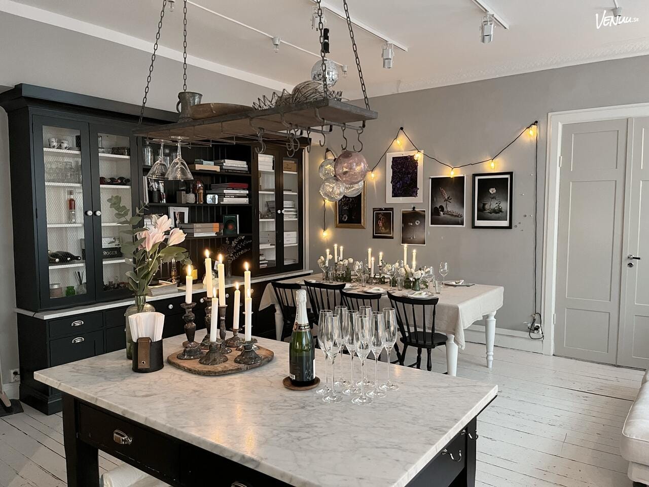 En ljus och flexibel studio med vita väggar och stora fönster, redo att dekoreras för evenemang.