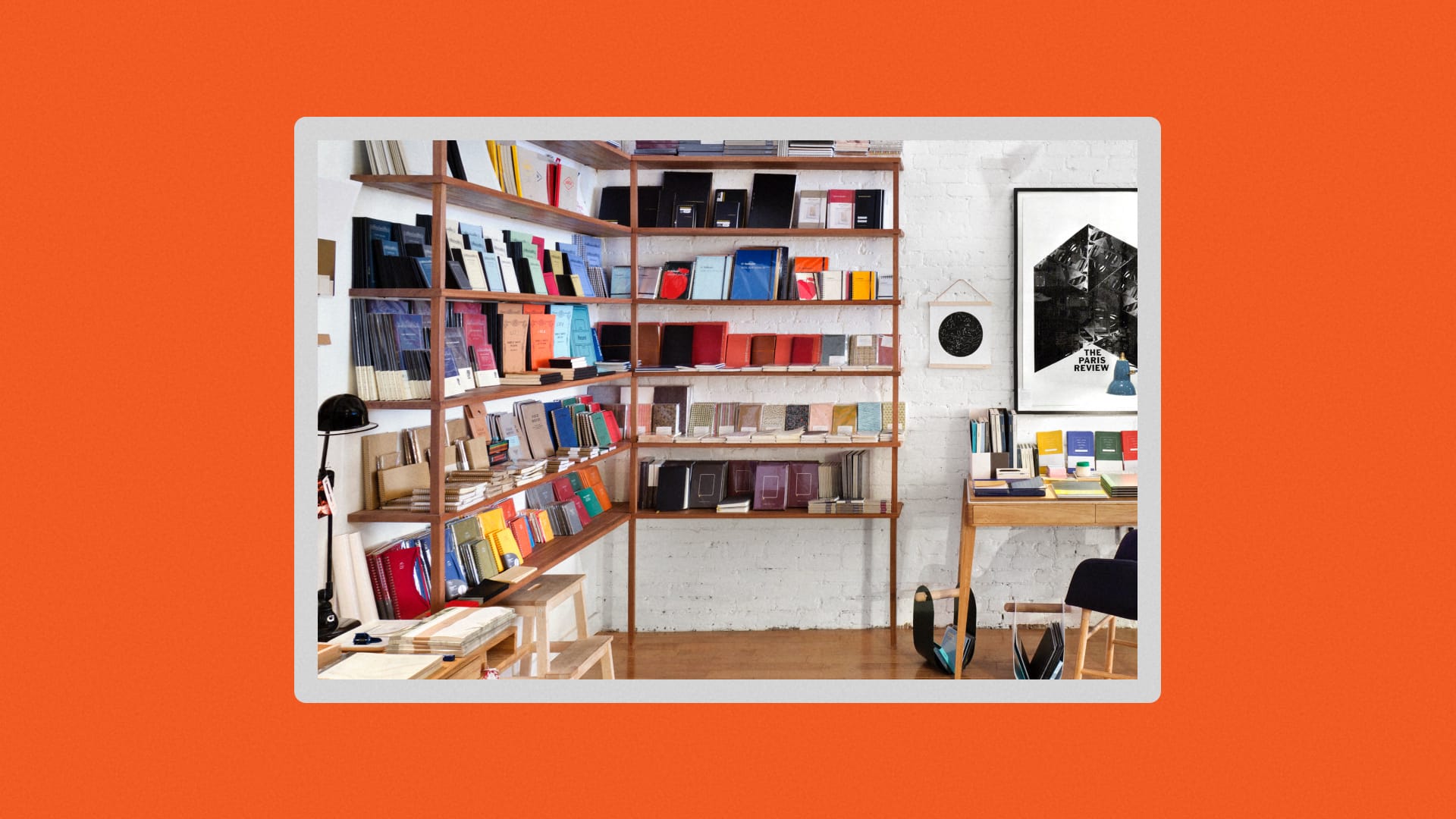 Pictured is a wall of notebooks against a white brick wall. 