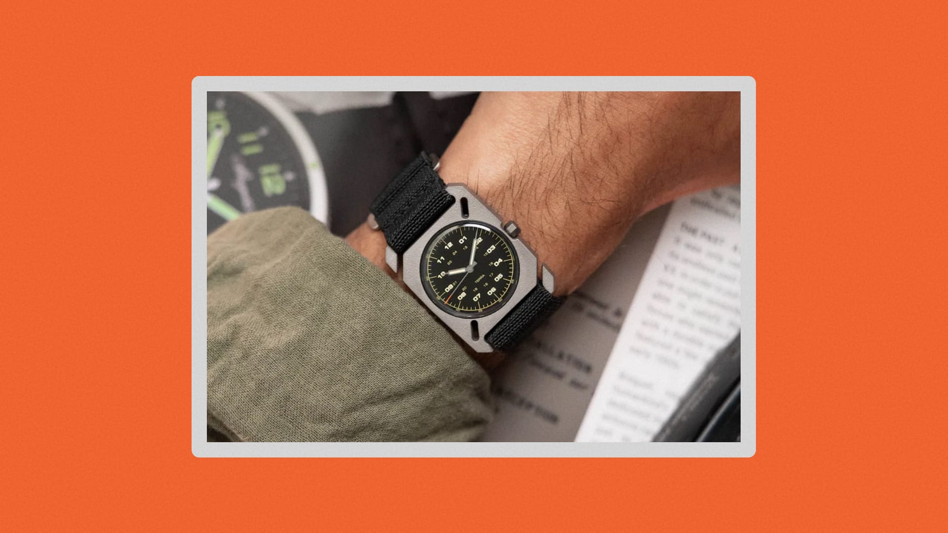 Man with a green shirt wearing the watch on a black strap.