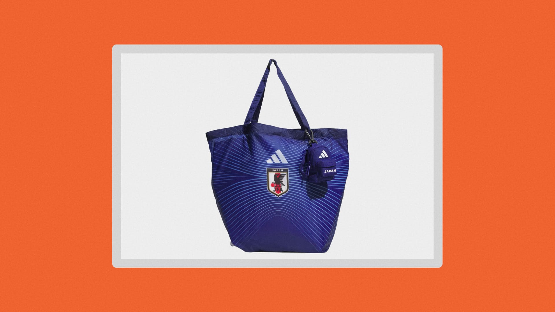 Blue tote bag with Japan team crest on it, plus a tiny backpack hanging off the side.