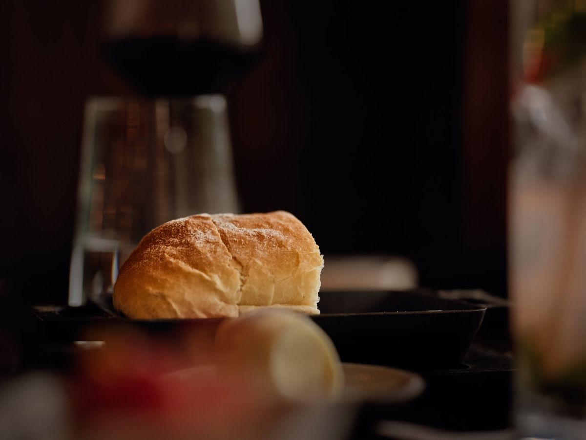 Bread on Steadfire Jackson Hole dinner table in low light at dinner between two people. 