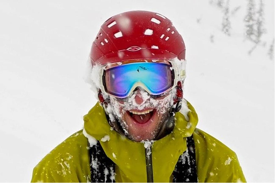 A skier with a powder-eating grin