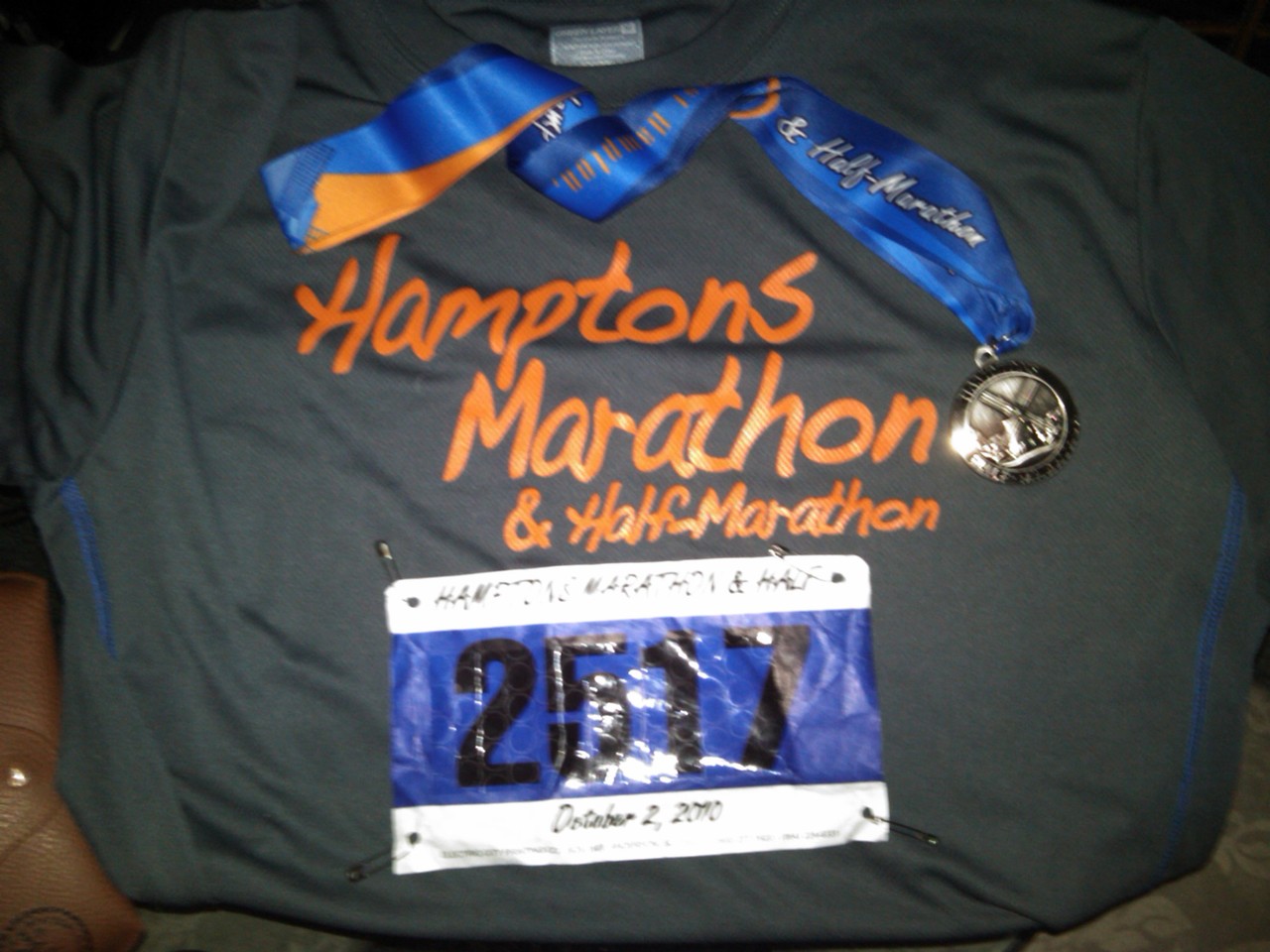 Grey Hamptons Marathon race shirt with finisher medal and bib number 2517 dated October 2, 2010.