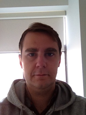 Clean-shaven Drew Shannon on Day One of Movember in a grey hoodie before starting the mustache challenge.