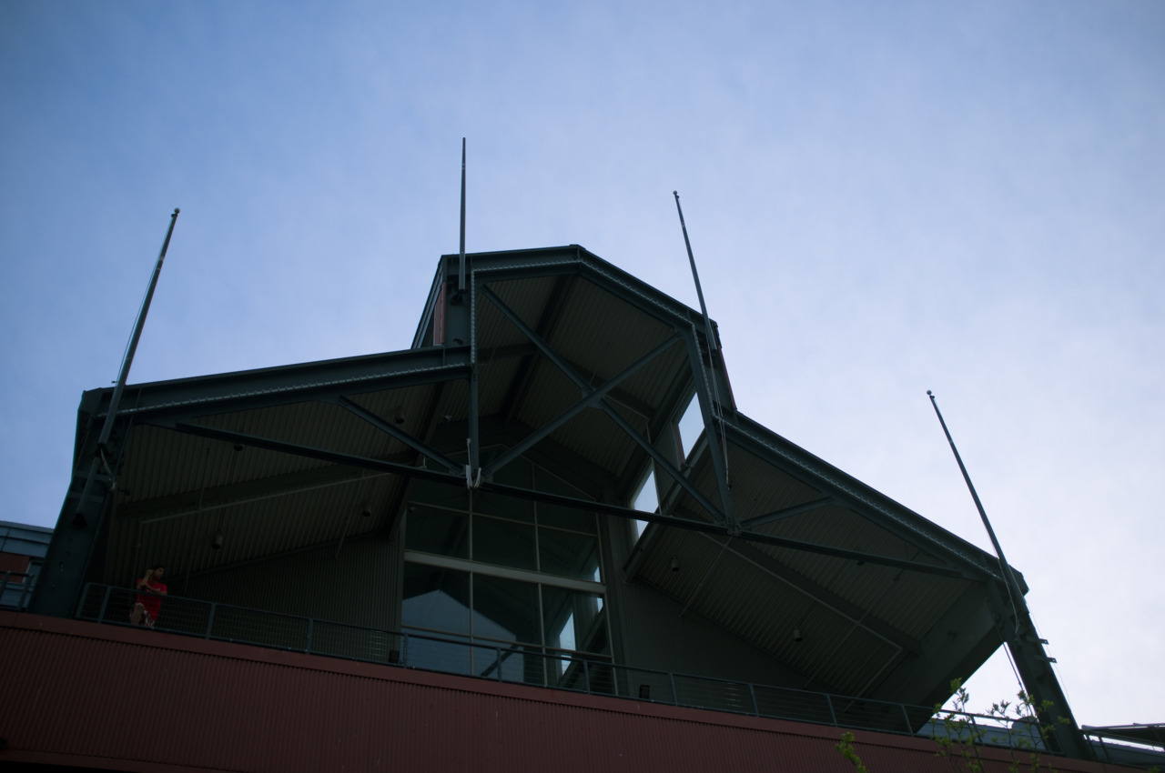 Metal roof trusses and spires of Pier 17 pavilion at South Street Seaport against a blue sky.
