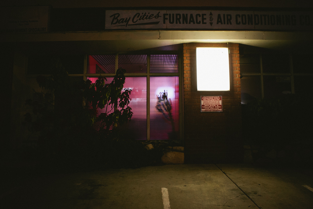 Bay Cities Furnace & Air Conditioning storefront with glowing signs at night in Santa Monica.